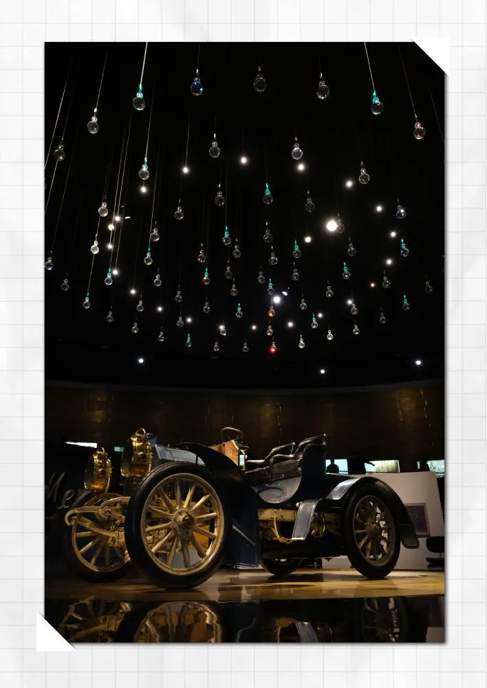 Classic automobile under suspended lights